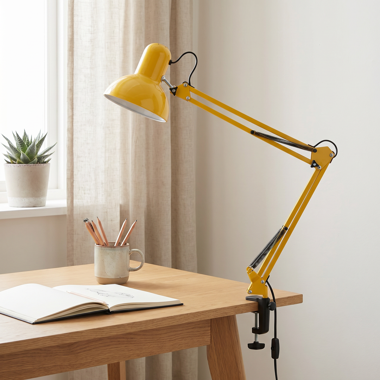 Otis architect clamp lamp in yellow on a desk