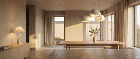Saku pebble pendant cluster over an oak dining table with a Sia table lamp, warm lifestyle scene