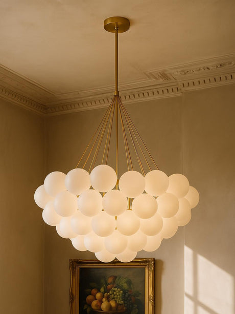 Perle 31-globe frosted glass bubble chandelier in gold in a plaster-moulded corner