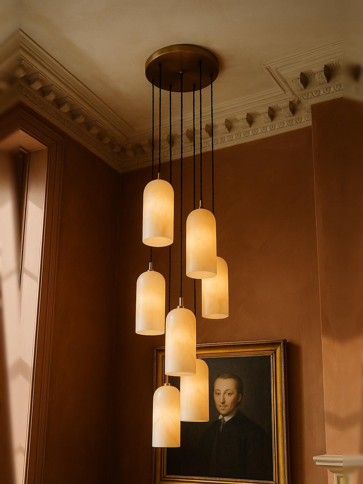 Sola seven-pendant alabaster cluster pendant in brass in a sienna plaster corner
