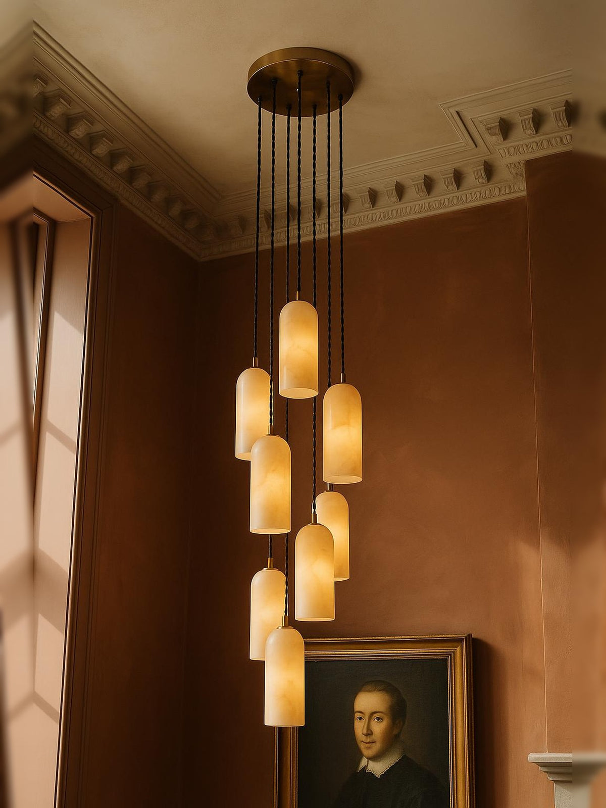 Sola nine-pendant alabaster cluster pendant in brass in a sienna plaster corner