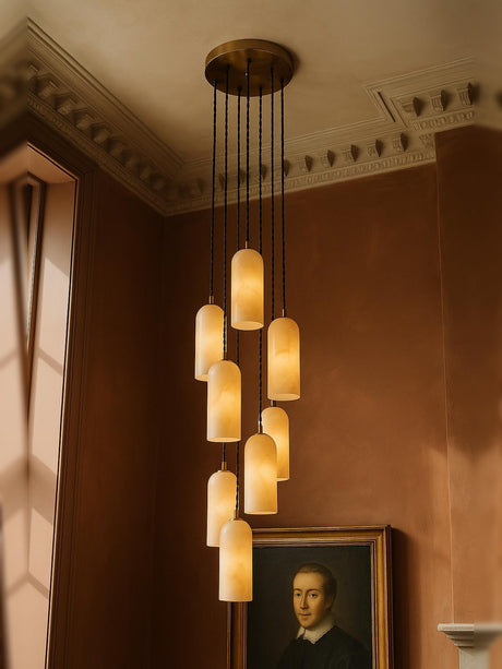 Sola nine-pendant alabaster cluster pendant in brass in a sienna plaster corner