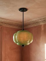 Ivy tall green glass semi-flush ceiling light in black hanging in a plaster-moulded corner