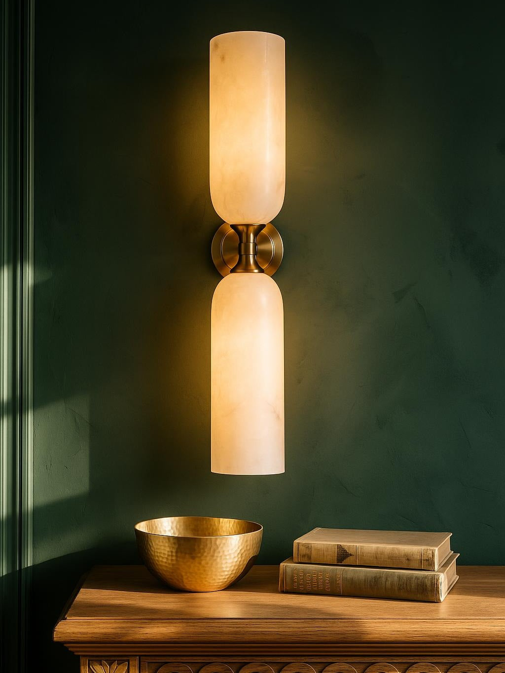 Nyx large up-and-down alabaster wall sconce in copper on a forest-green plaster wall