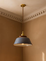 Delft blue ring ceramic pendant light hanging in a plaster-moulded corner