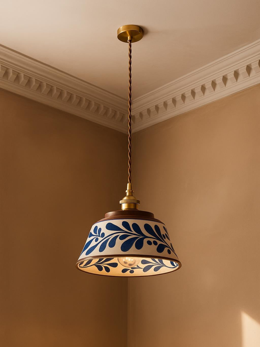Delft blue vine ceramic pendant light hanging in a plaster-moulded corner