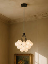 Perle 19-globe frosted glass bubble chandelier in black in a plaster-moulded corner