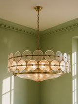Soleil 31.5-inch clear glass disc chandelier hanging in a plaster-moulded corner