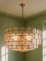 Soleil 37.4-inch clear glass disc chandelier hanging in a plaster-moulded corner