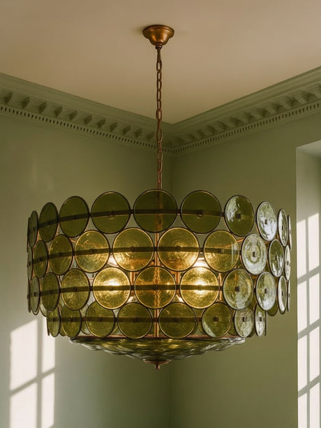 Soleil 37.4-inch olive-green glass disc chandelier hanging in a plaster-moulded corner