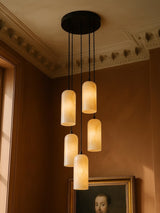 Sola five-pendant alabaster cluster pendant in black in a sienna plaster corner