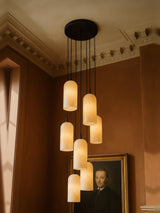 Sola seven-pendant alabaster cluster pendant in black in a sienna plaster corner