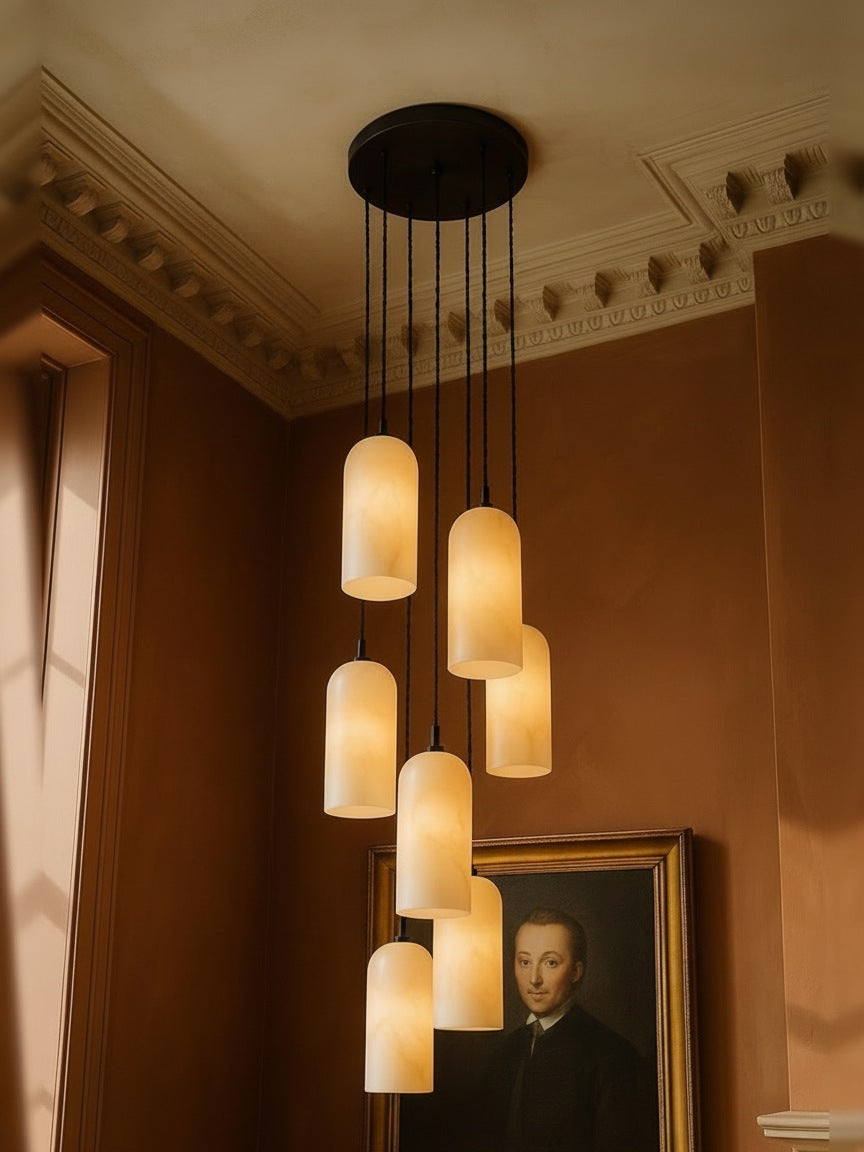 Sola seven-pendant alabaster cluster pendant in black in a sienna plaster corner