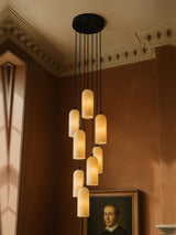 Sola nine-pendant alabaster cluster pendant in black in a sienna plaster corner
