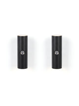 A matched pair of Vega wall lights on white, glowing up and down