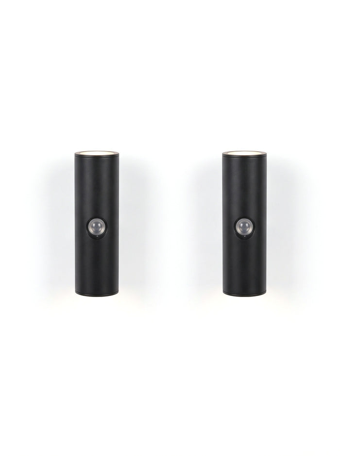 A matched pair of Vega wall lights on white, glowing up and down