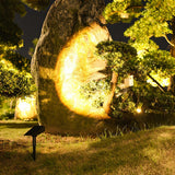 Vale spotlight lighting a garden rock feature
